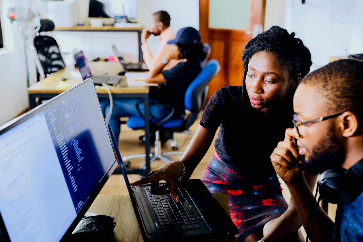Two vetted professionals focused on delivery at a screen