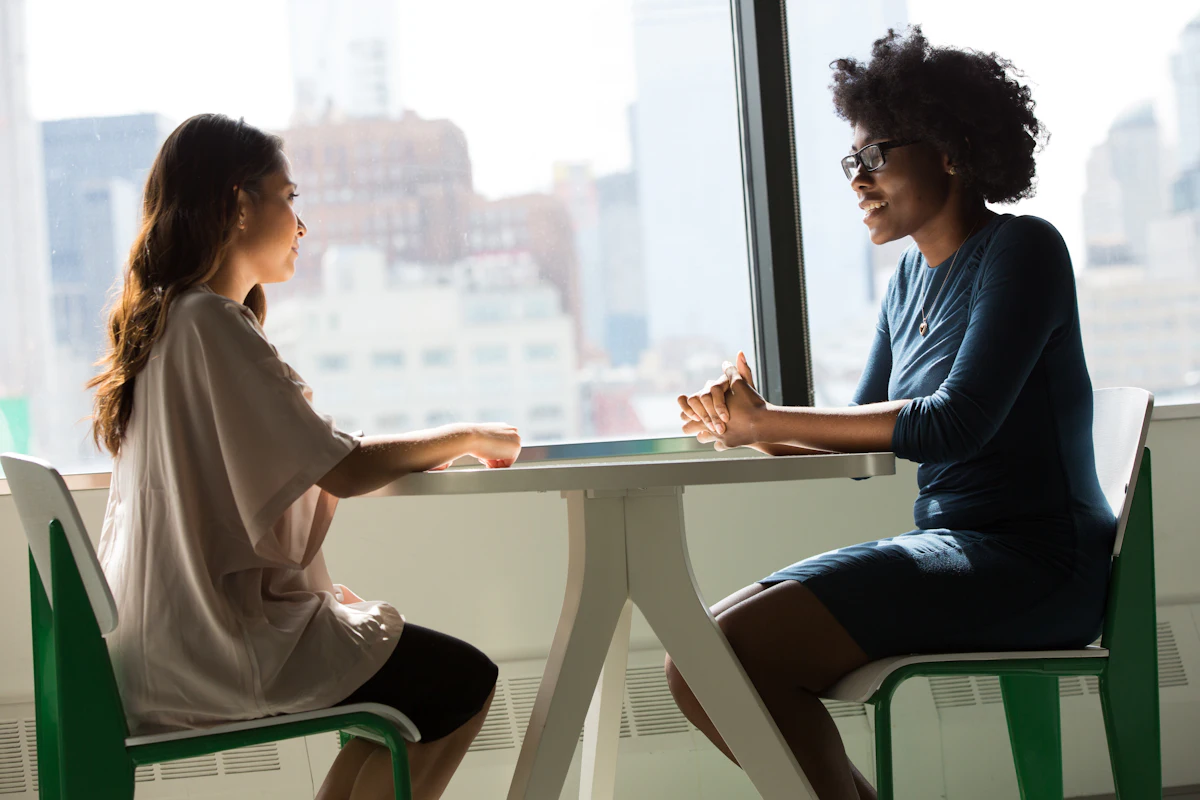 Two professionals in a focused, accountable working conversation